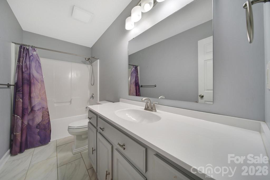 4394 Mountain Creek Road Iron Station, NC 28080 - Photo 12 of 45 a bathroom with a sink vanity granite and toilet