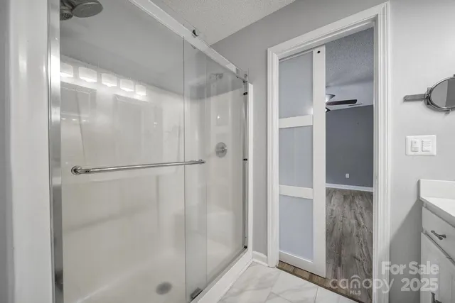 a bathroom with a glass shower door
