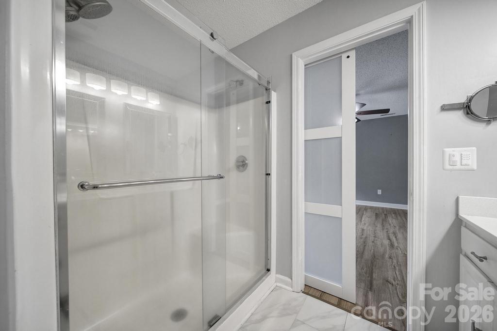 4394 Mountain Creek Road Iron Station, NC 28080 - Photo 23 of 45 a bathroom with a glass shower door
