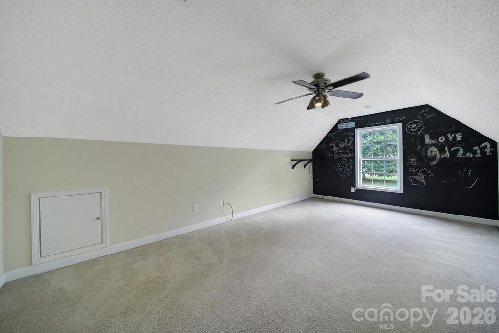 4394 Mountain Creek Road Iron Station, NC 28080 - Photo 25 of 45 en empty room with windows and ceiling fan