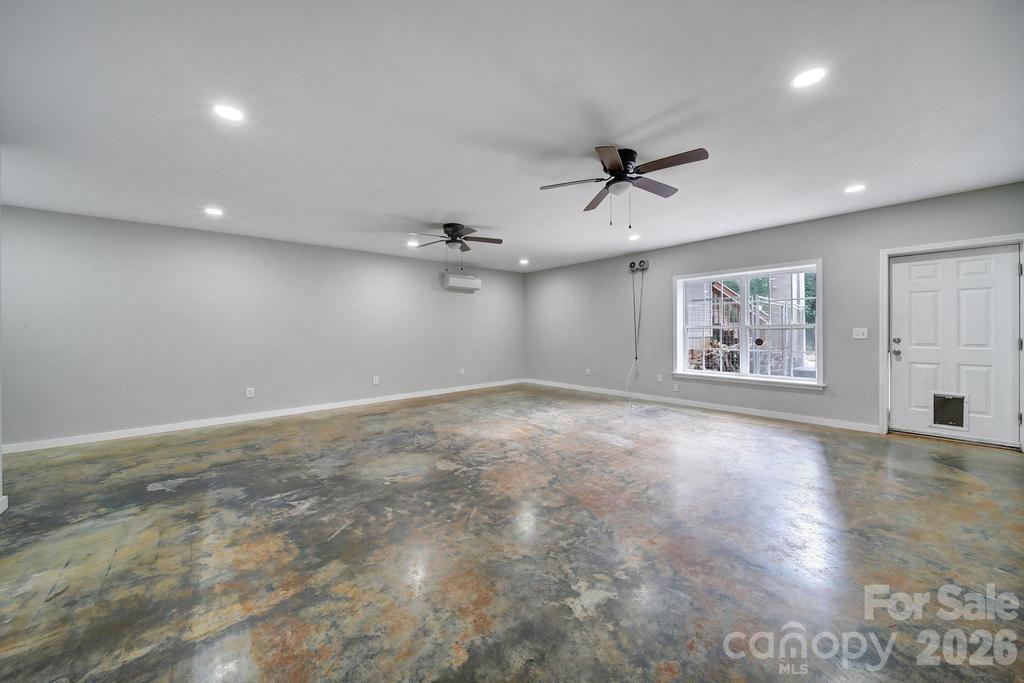 4394 Mountain Creek Road Iron Station, NC 28080 - Photo 26 of 45 an empty room with windows and ceiling fan