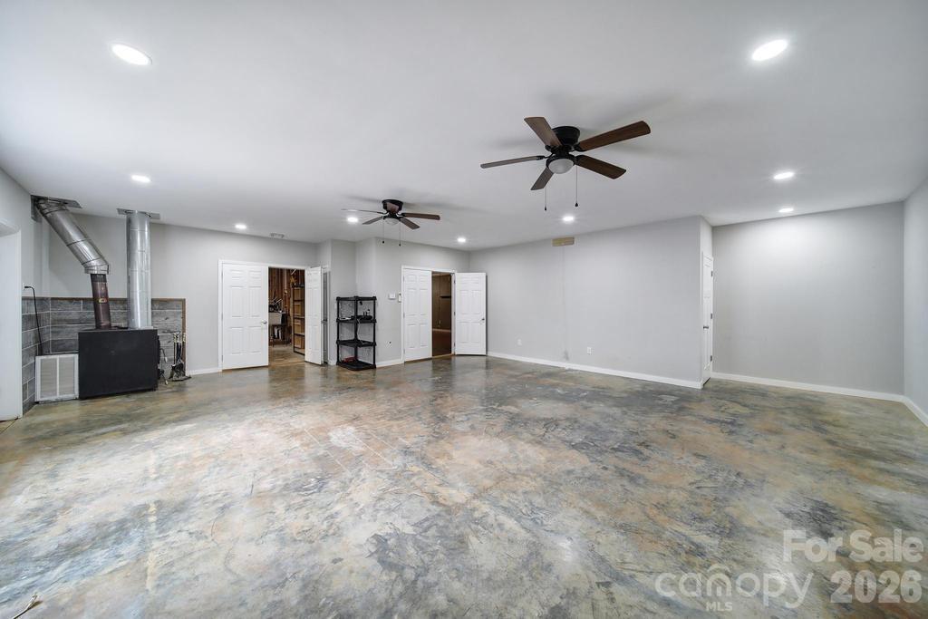 4394 Mountain Creek Road Iron Station, NC 28080 - Photo 27 of 45 an empty room with a ceiling fan and window