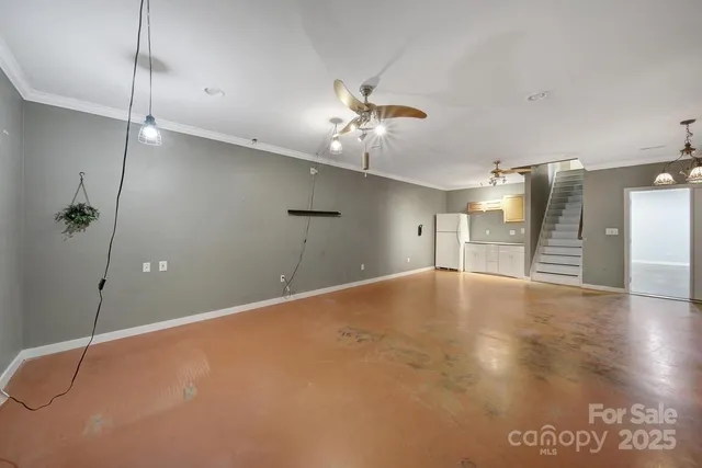 a view of an empty room with a ceiling fan