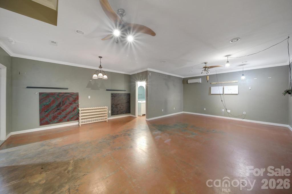 4394 Mountain Creek Road Iron Station, NC 28080 - Photo 30 of 45 a view of an empty room with a chandelier fan and a window