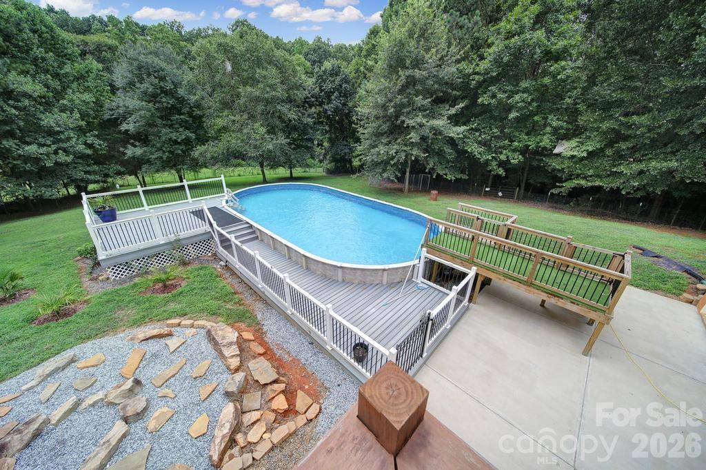 4394 Mountain Creek Road Iron Station, NC 28080 - Photo 33 of 45 a view of a backyard with a small deck and a garden