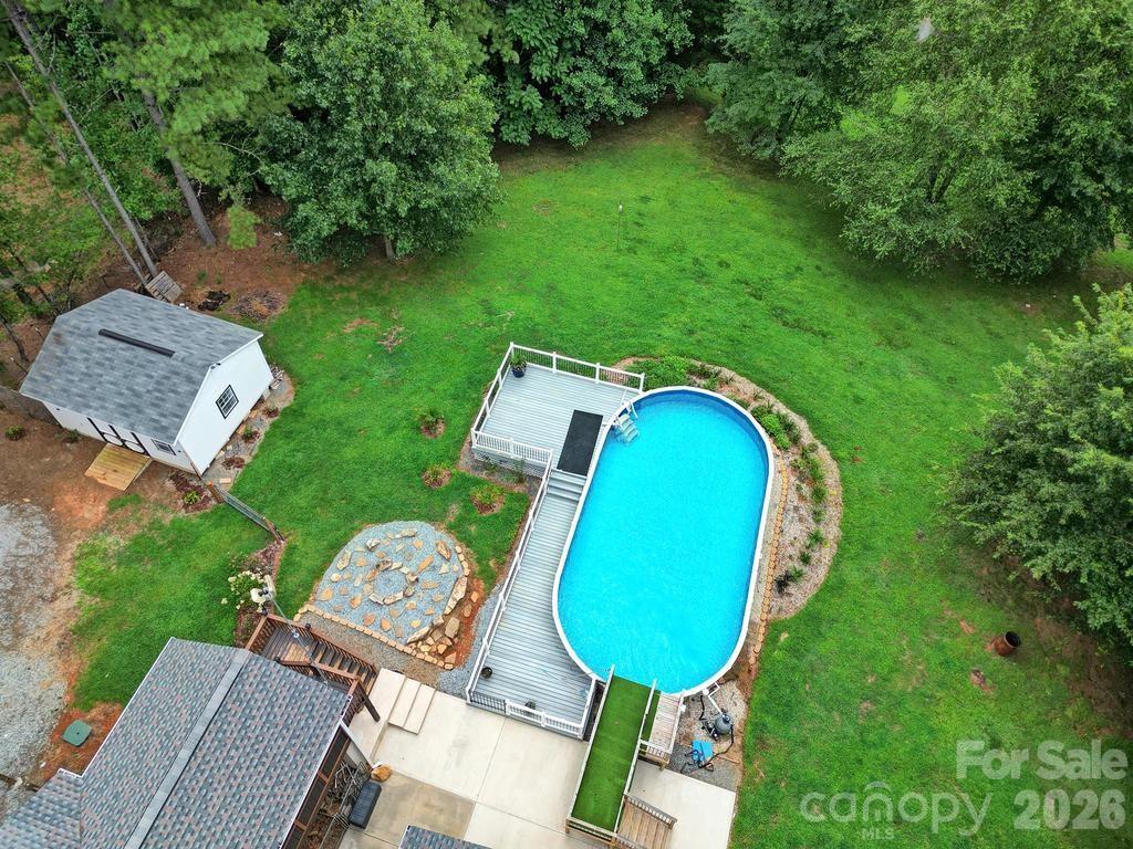 4394 Mountain Creek Road Iron Station, NC 28080 - Photo 43 of 45 an aerial view of a house with swimming pool and trees all around