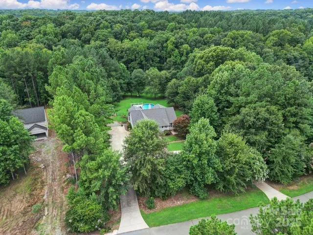 an aerial view of a house with yard