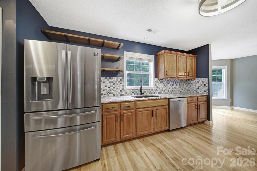 4394 Mountain Creek Road Iron Station, NC 28080 - Photo 10 of 45 a kitchen with stainless steel appliances granite countertop a refrigerator and a sink
