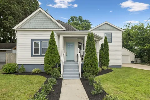 a front view of a house with garden