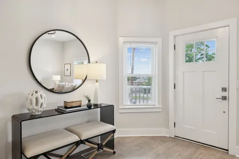 a spacious bedroom with a bed a table and chair