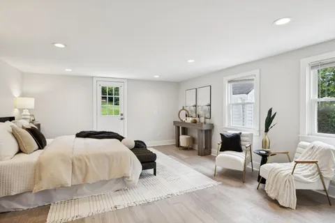 a bathroom with granite countertop white cabinets and a sink
