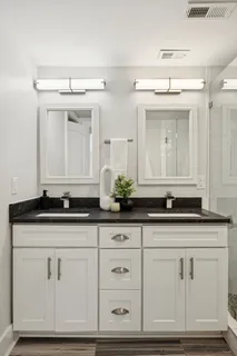 a backyard of a house with lots of plants and tree