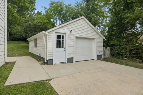 a front view of a house with a garden and yard