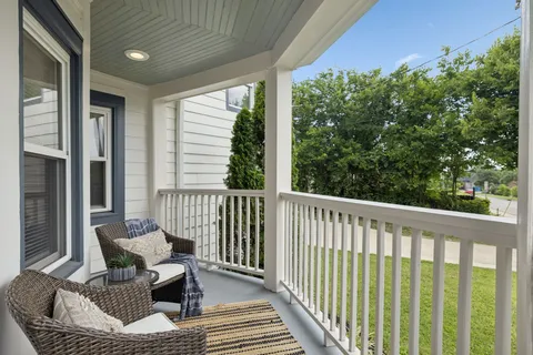 a living room with lots of furniture and kitchen view