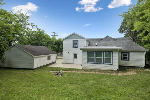 an aerial view of a house with a yard