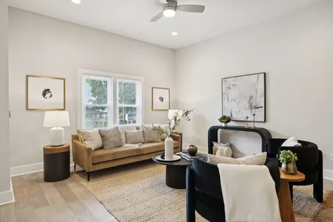 a living room with furniture and a potted plant