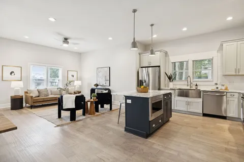 a kitchen with stainless steel appliances granite countertop a sink stove and refrigerator