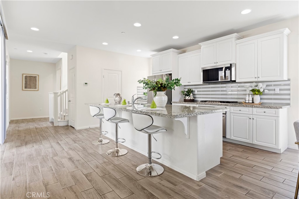 202 Cultivate Irvine, CA 92618 - Photo 16 of 65 a kitchen with stainless steel appliances kitchen island granite countertop a stove a sink and a refrigerator