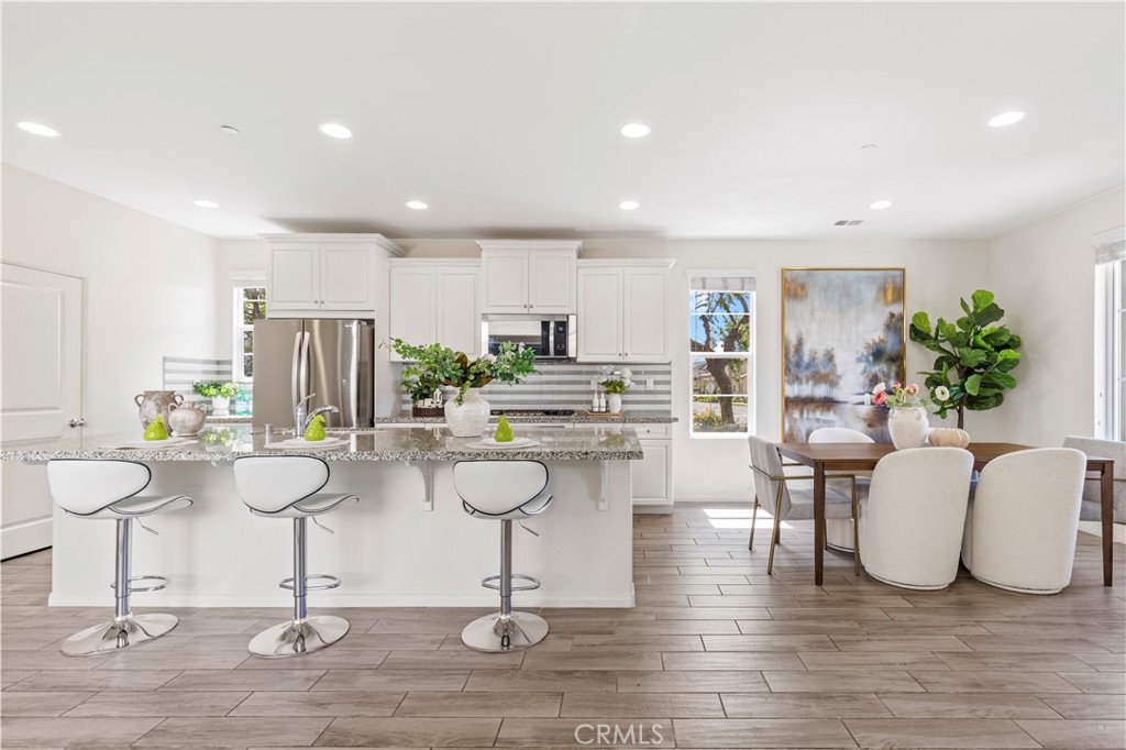 202 Cultivate Irvine, CA 92618 - Photo 17 of 65 a living room with kitchen island furniture and a chandelier