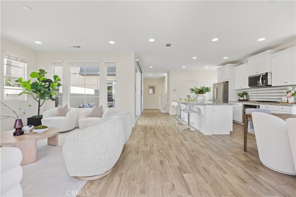 202 Cultivate Irvine, CA 92618 - Photo 2 of 65 a living room with kitchen island furniture and a potted plant