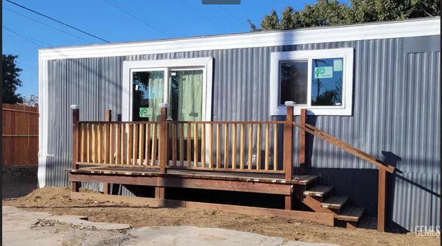 a view of a house with a wooden fence