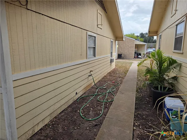 a kitchen with granite countertop white cabinets and a sink