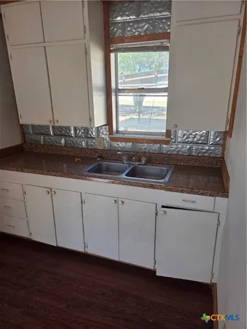 a kitchen with stainless steel appliances granite countertop a refrigerator a sink a stove a microwave and wooden cabinets