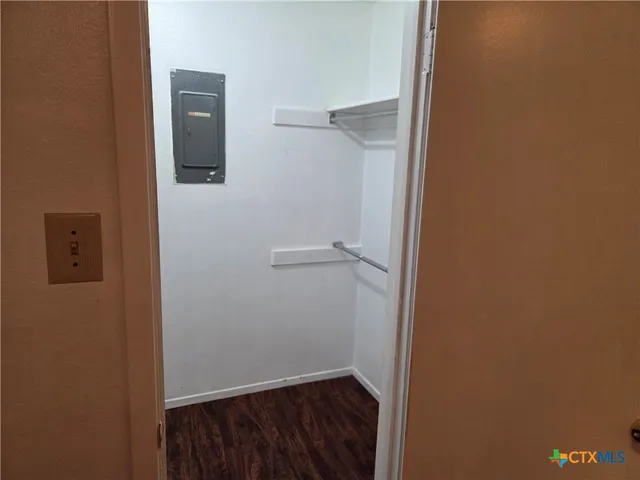 an empty room with windows and closet