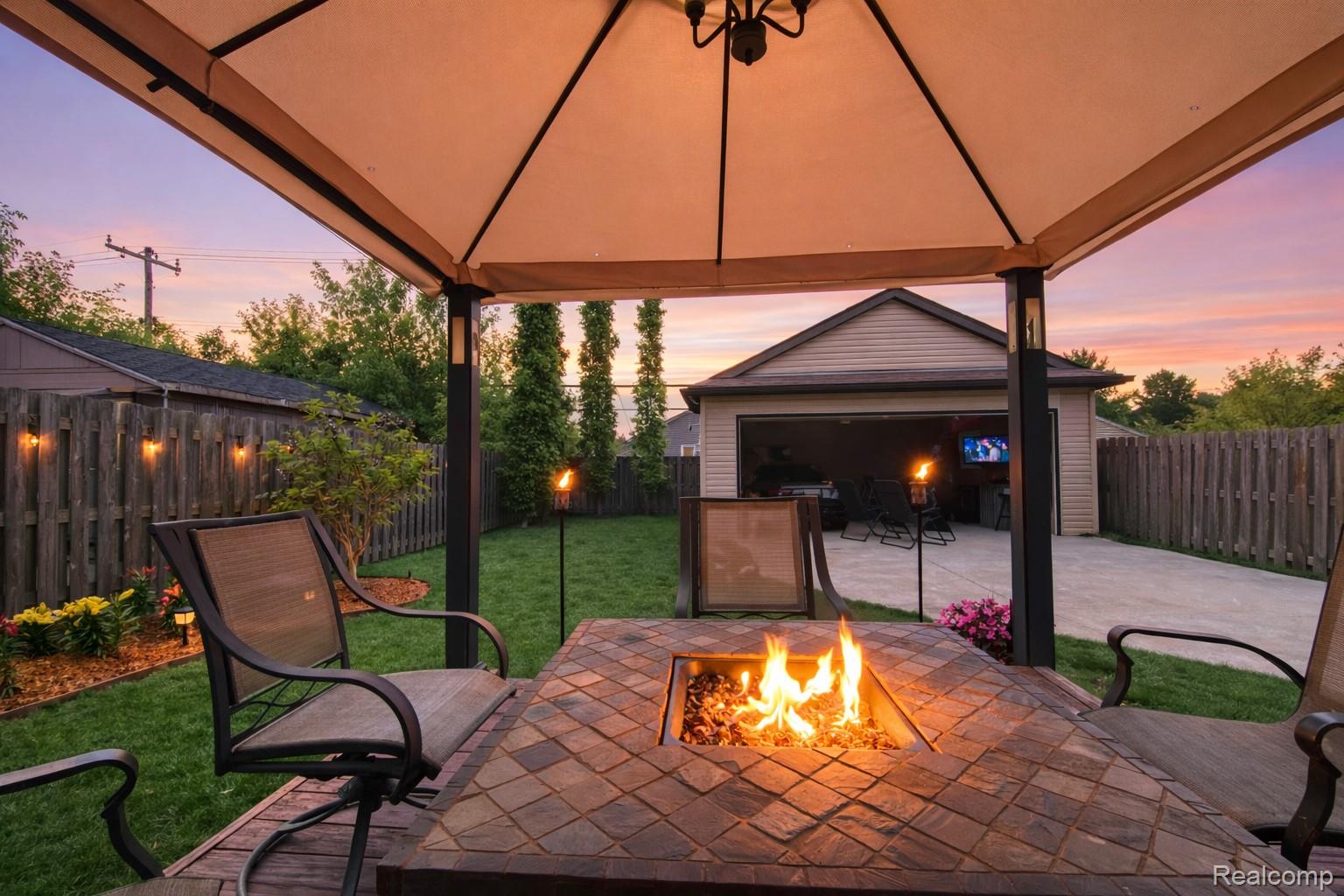 1162 West Eleven Mile Road Berkley, MI 48072 - Photo 2 of 33 Patio terrace at dusk with a patio area and a fenced backyard