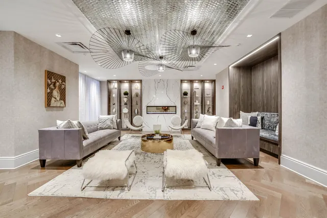 a living room with furniture and a chandelier