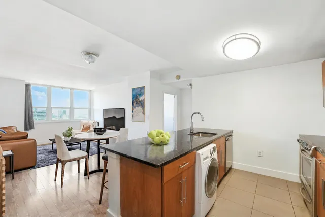 a view of a kitchen area with furniture and wooden floor