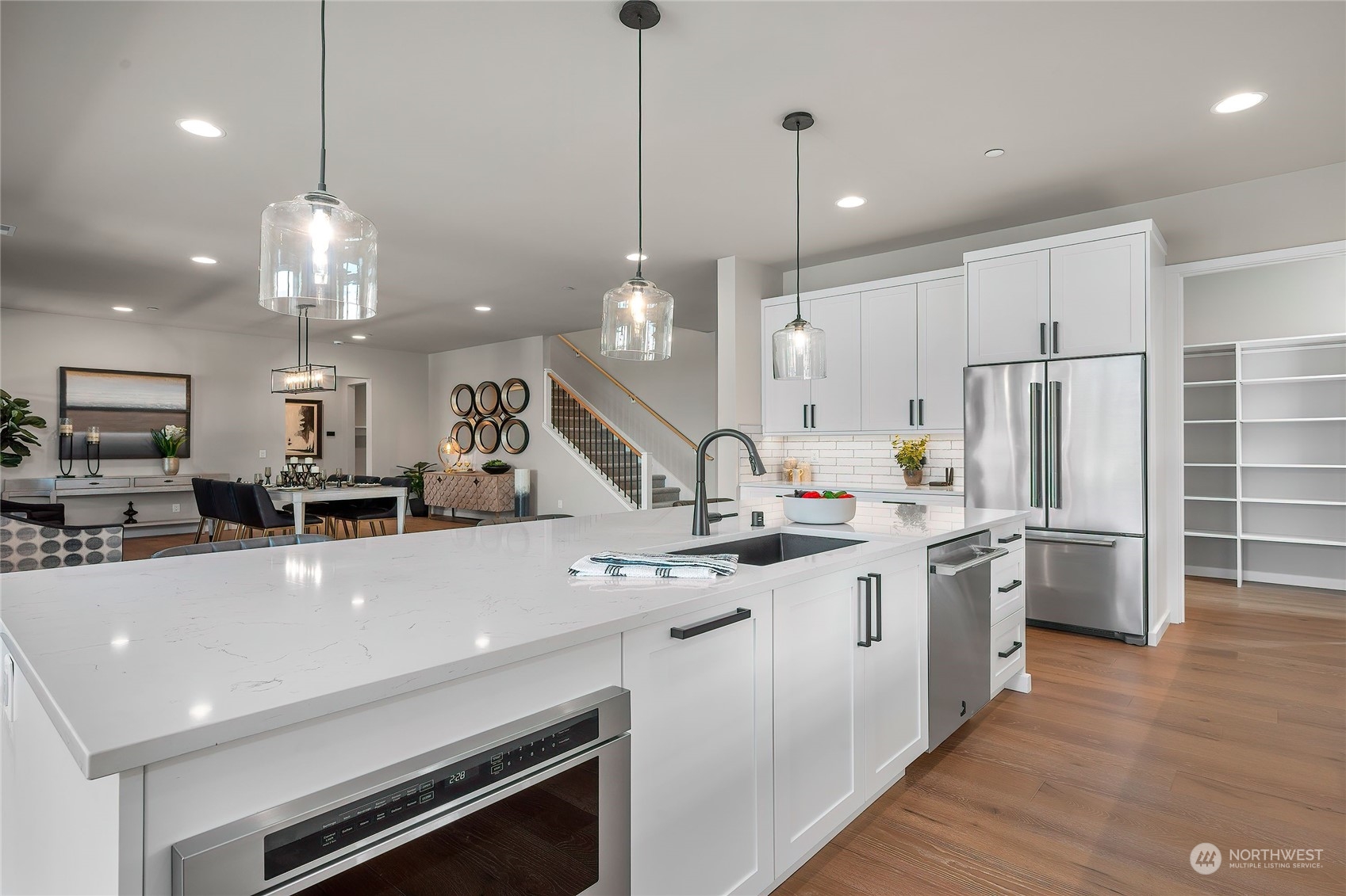23603 23rd Avenue Southeast Bothell, WA 98021 - Photo 13 of 40 a large kitchen with kitchen island a stove a center island a sink cabinets and wooden floor