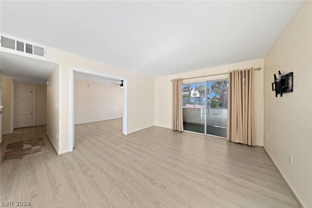 3425 East Russell Road, Unit 126 Las Vegas, NV 89120 - Photo 3 of 22 OPEN LIVING/DEN AREA WITH LVP FLOORING