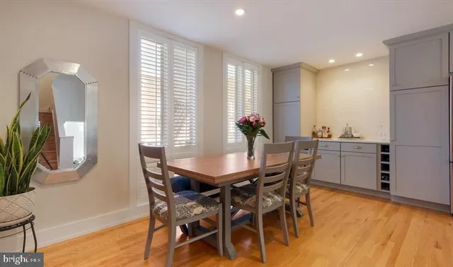 a view of a dining room with furniture and a large window