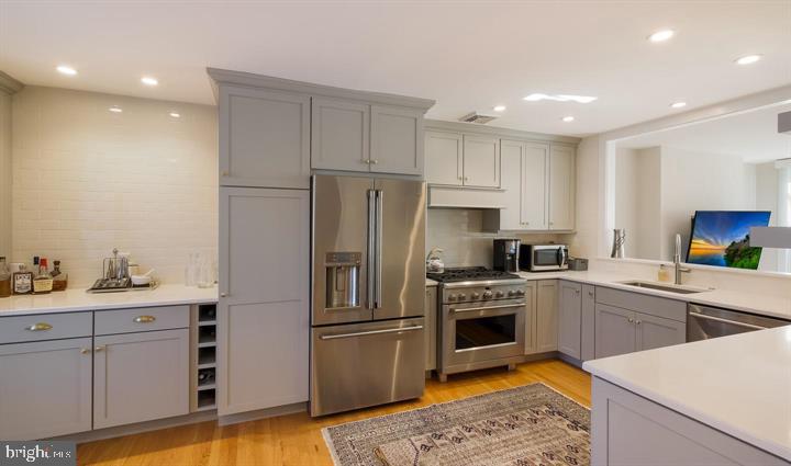 508 Addison Street Philadelphia, PA 19147 - Photo 7 of 14 a kitchen with white cabinets and stainless steel appliances