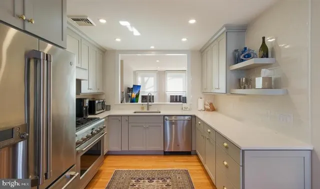 a kitchen with a sink stove and refrigerator