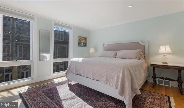 508 Addison Street Philadelphia, PA 19147 - Photo 9 of 14 a bedroom with a bed and a mirror on dresser