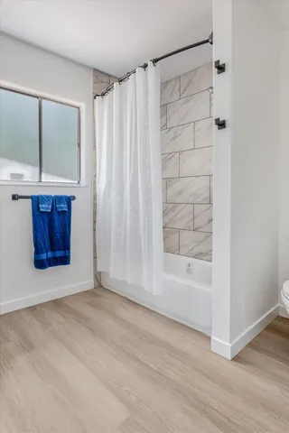 a bedroom with a bed and a painting on the wall