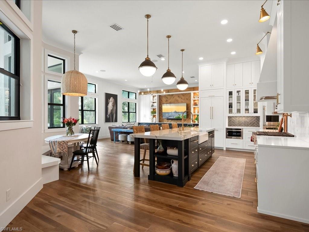 2590 2nd Street Northwest Naples, FL 34120 - Photo 10 of 49 Entering into the kitchen from the living room you'll realize truly how spacious and accommodating this home is with the oversized family room flanking the opposite side of the kitchen.