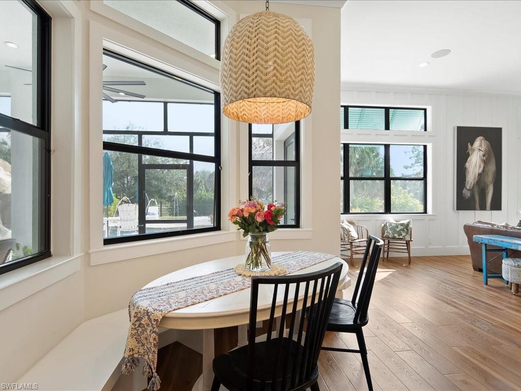 2590 2nd Street Northwest Naples, FL 34120 - Photo 11 of 49 A custom built-in banquette was added to allow a maximum amount of guests around the breakfast table.