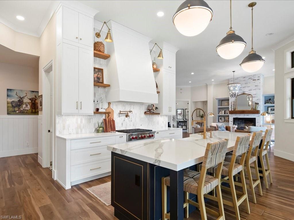 2590 2nd Street Northwest Naples, FL 34120 - Photo 12 of 49 The two-tone cabinetry and sleek, modern pendants are a few of the many thoughtful details implemented by Design & Company.