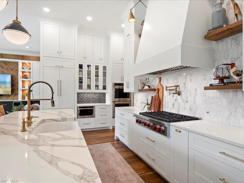 2590 2nd Street Northwest Naples, FL 34120 - Photo 14 of 49 Floating shelves, glass front doors, and a 6-burner Wolf gas range with a pot filler check all the boxes (connected to the 1,000 gallon buried propane tank)