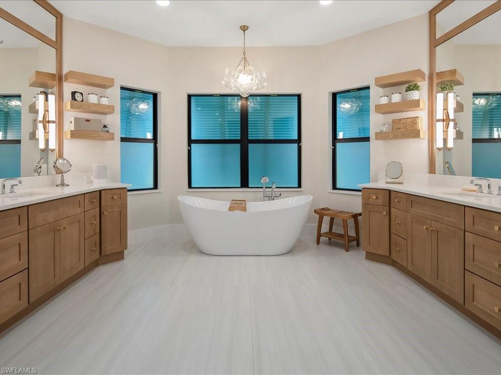 2590 2nd Street Northwest Naples, FL 34120 - Photo 23 of 49 The master bathroom renovation was completed in early 2025 and features a modern, sleep soaking tub. The new Bahamas shutters provide privacy while still allowing natural light to flow in.