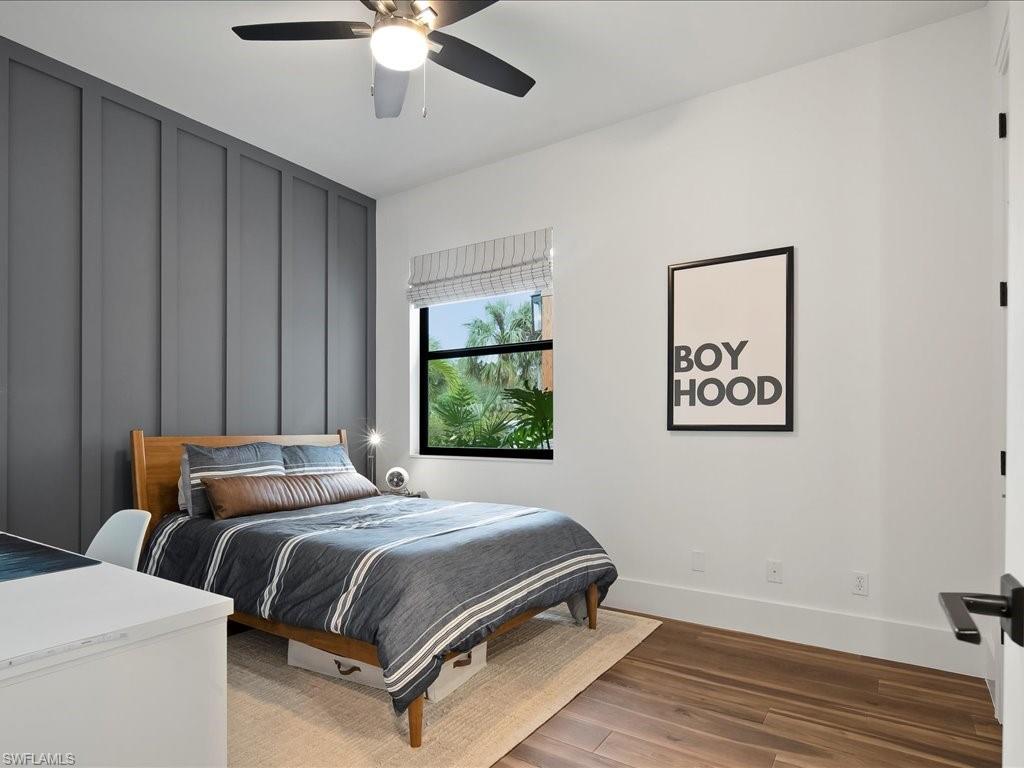 2590 2nd Street Northwest Naples, FL 34120 - Photo 33 of 49 The fourth bedroom is ensuite and features a walk in closet with custom PLC shelving, ceiling fan, room darkening shades, and shiplap.