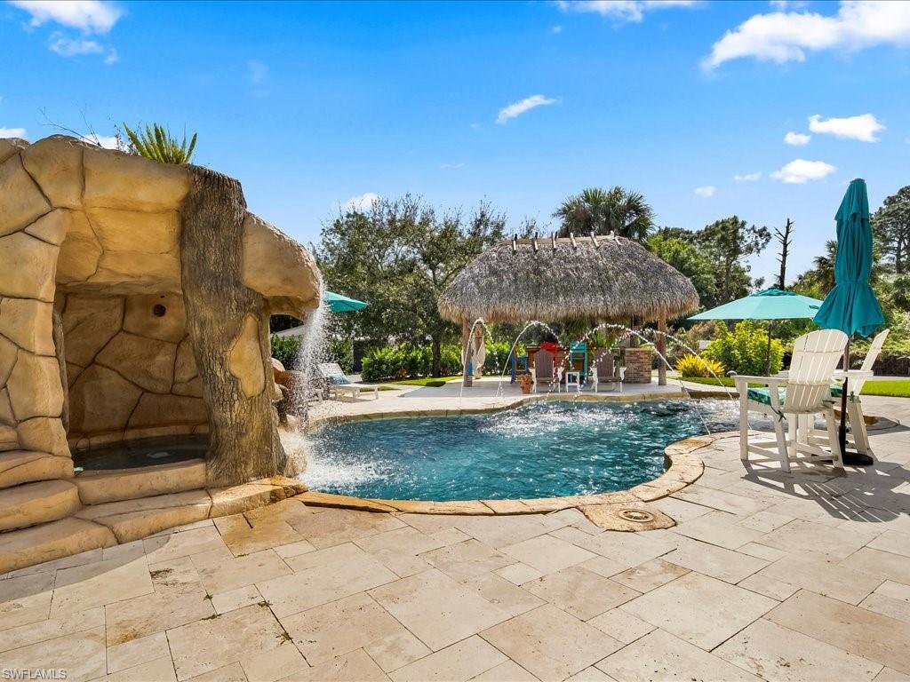2590 2nd Street Northwest Naples, FL 34120 - Photo 40 of 49 The waterslide is SO much fun but safety is paramount, so the owners recently installed a custom iron fence around the entire pool area.