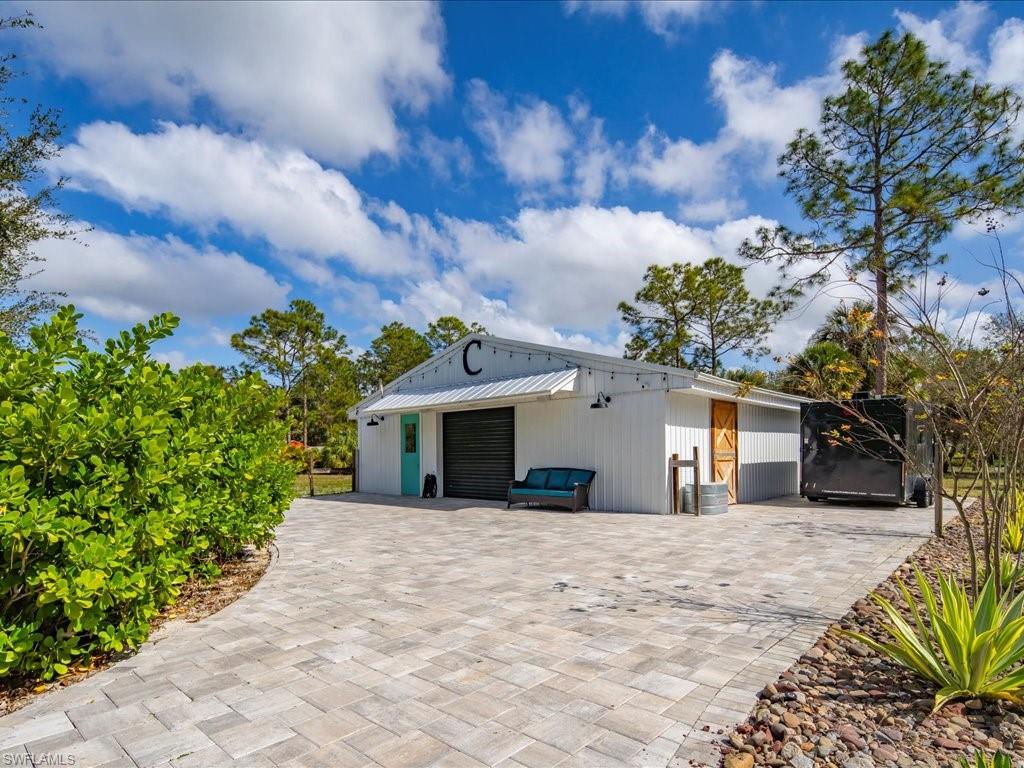 2590 2nd Street Northwest Naples, FL 34120 - Photo 44 of 49 In addition to the over-sized 3-car garage, this property also has an incredible barn that can meet so many uses. It was transformed from a horse barn and could easily be converted back.