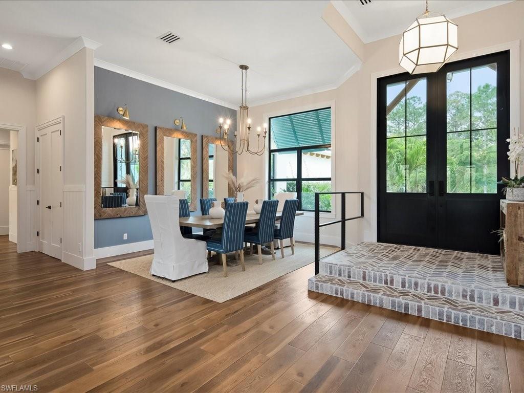 2590 2nd Street Northwest Naples, FL 34120 - Photo 5 of 49 The interior of the foyer was also structurally reconfigured to open up the dining room. In the process, the beautiful brick entryway was added along with the custom iron rail.