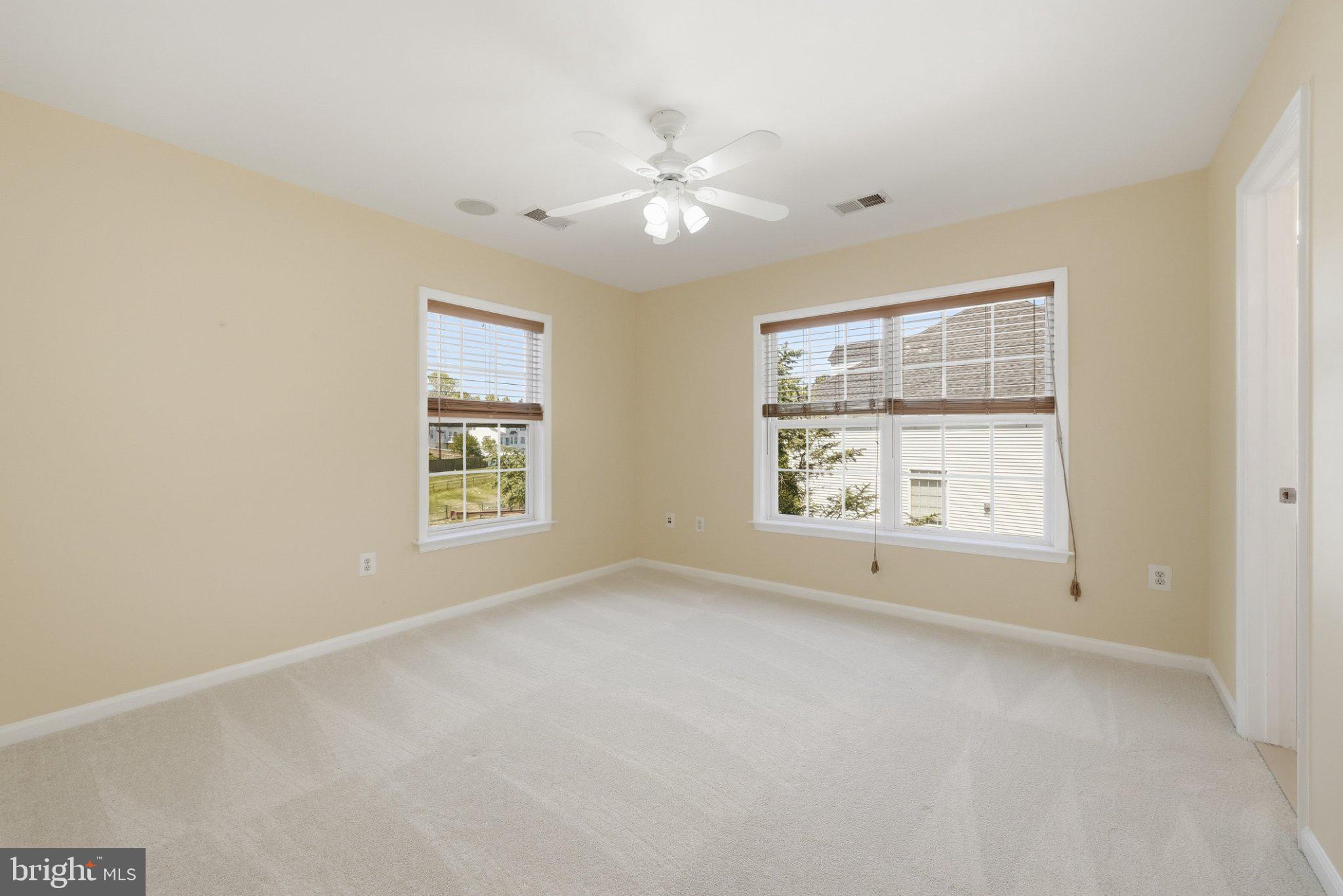 3679 Expedition Drive Triangle, VA 22172 - Photo 36 of 65 an empty room with chandelier fan and windows