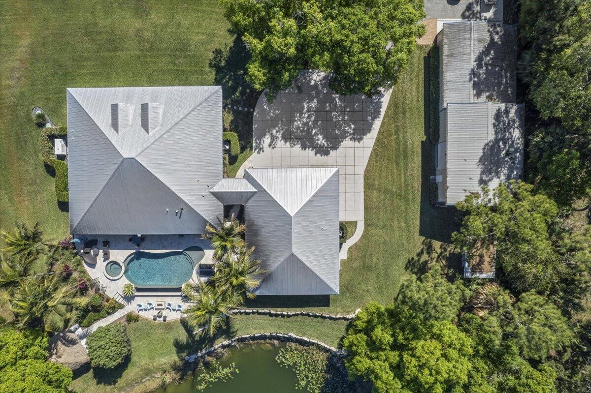 10975 Randolph Siding Road Jupiter, FL 33478 - Photo 89 of 97 an aerial view of a house with swimming pool and lawn chairs