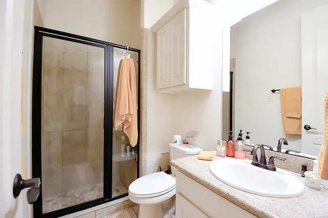 a kitchen with kitchen island granite countertop a sink a center island a stove and a cabinets